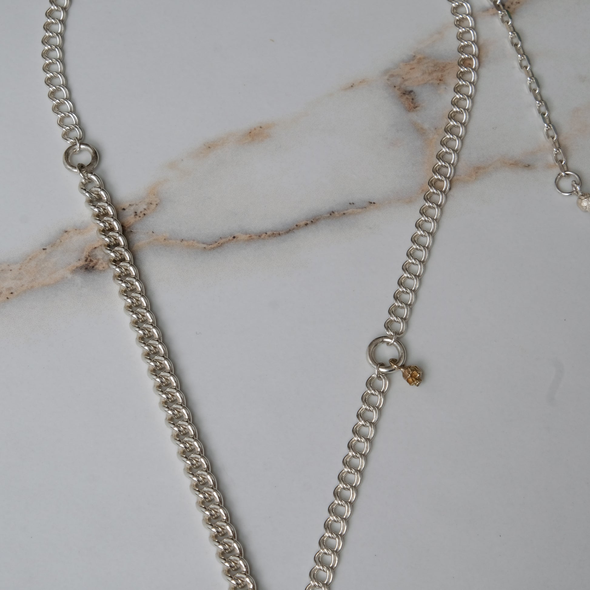 Sterling silver mix-matched curb link chain necklace with 9ct yellow gold jump ring details, old skull and hanging silver and flouish pendant with pearl. Handmade in London by Charlie Shires