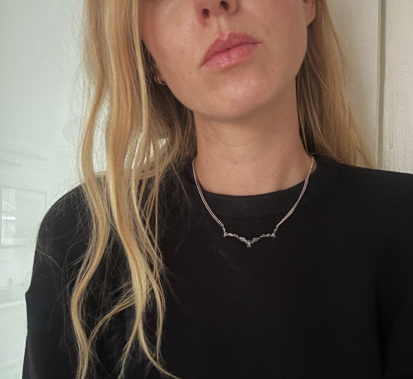 Three bat necklace on curb link chain, made in sterling silver by Charlie Shires in London