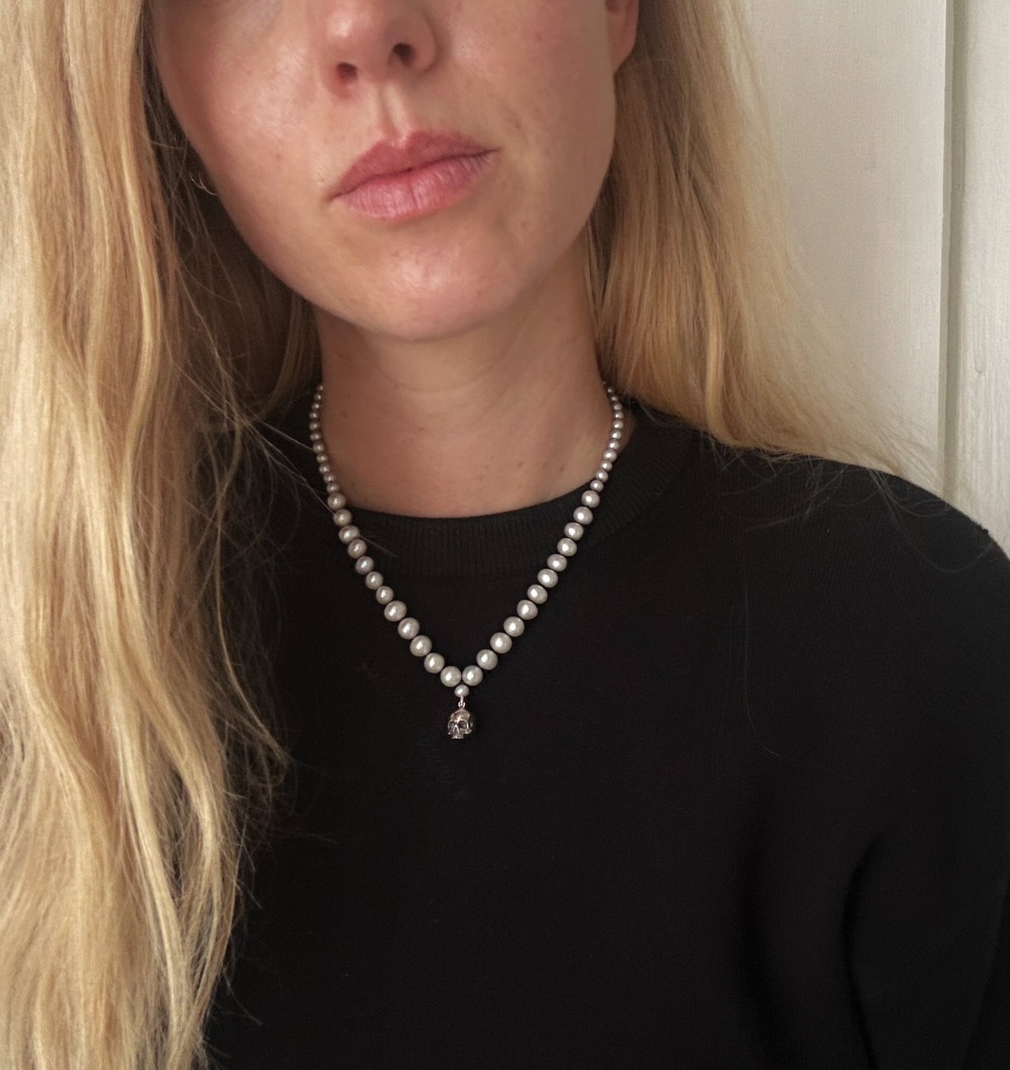 Hand strung grey freshwater pearls with a large sterling silver skull, made by hand in London by Charlie Shires