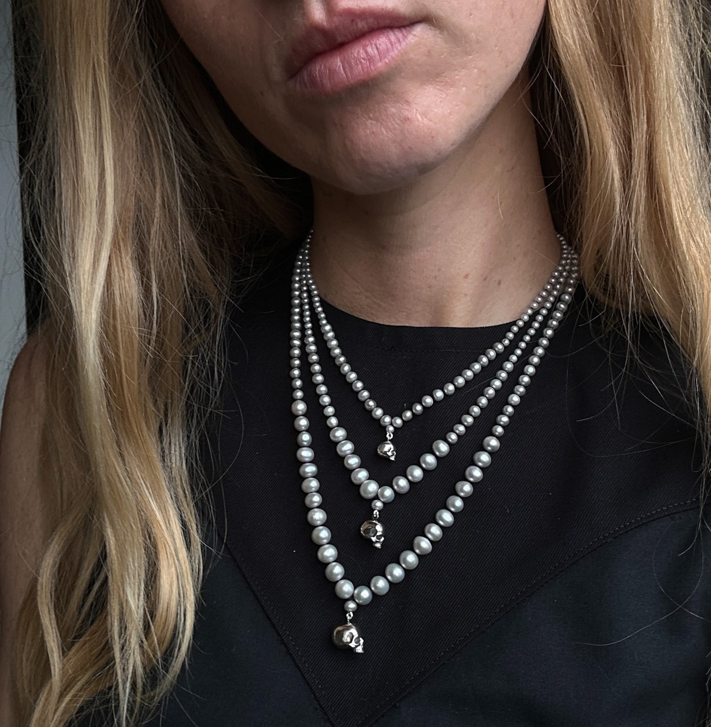 Hand strung grey freshwater pearls with a small, medium and large sterling silver skull, made by hand in London by Charlie Shires