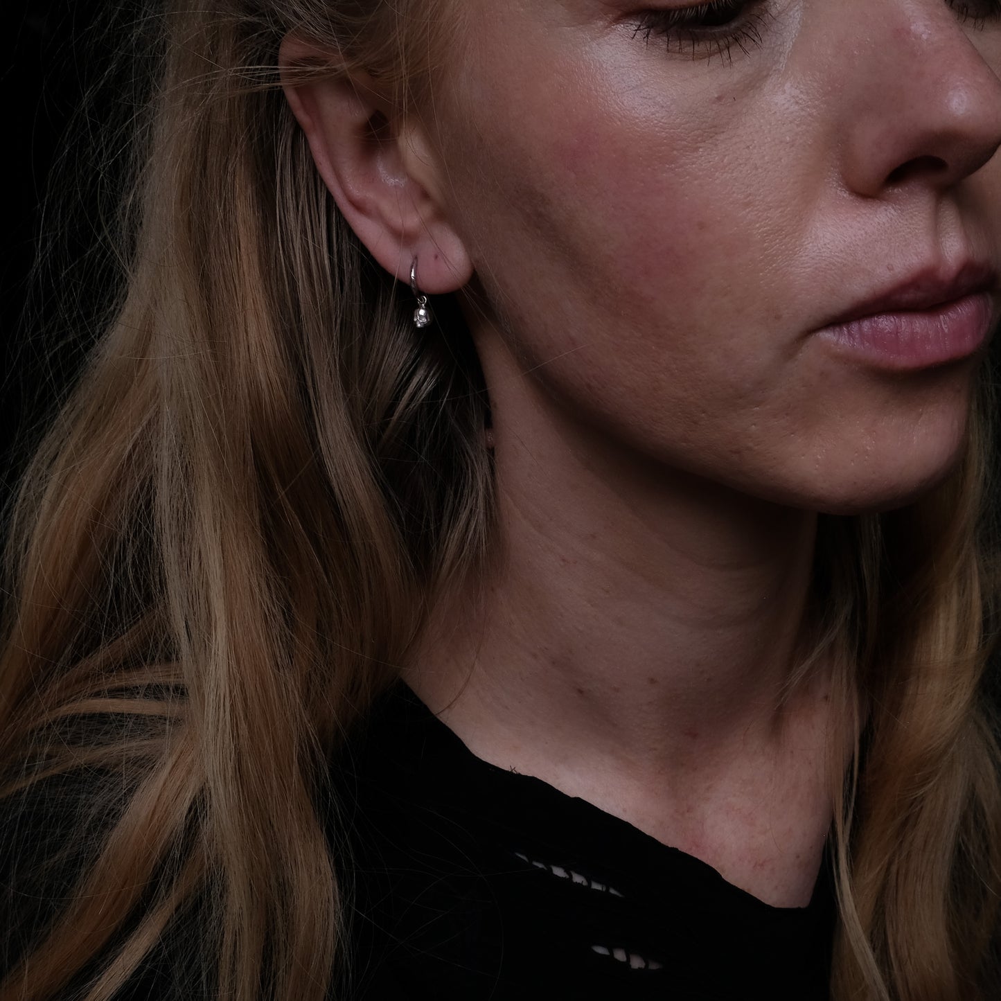 Sterling silver skull huggie hoop earrings made in London by Charlie Shires