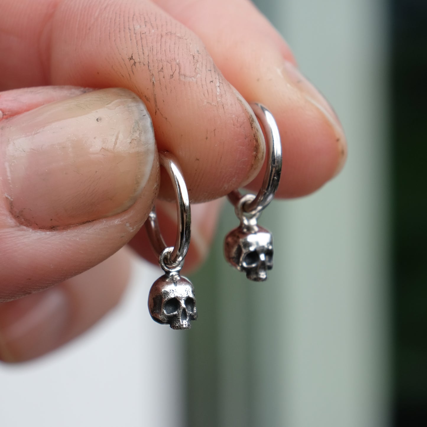 Sterling silver skull huggie hoop earrings made in London by Charlie Shires