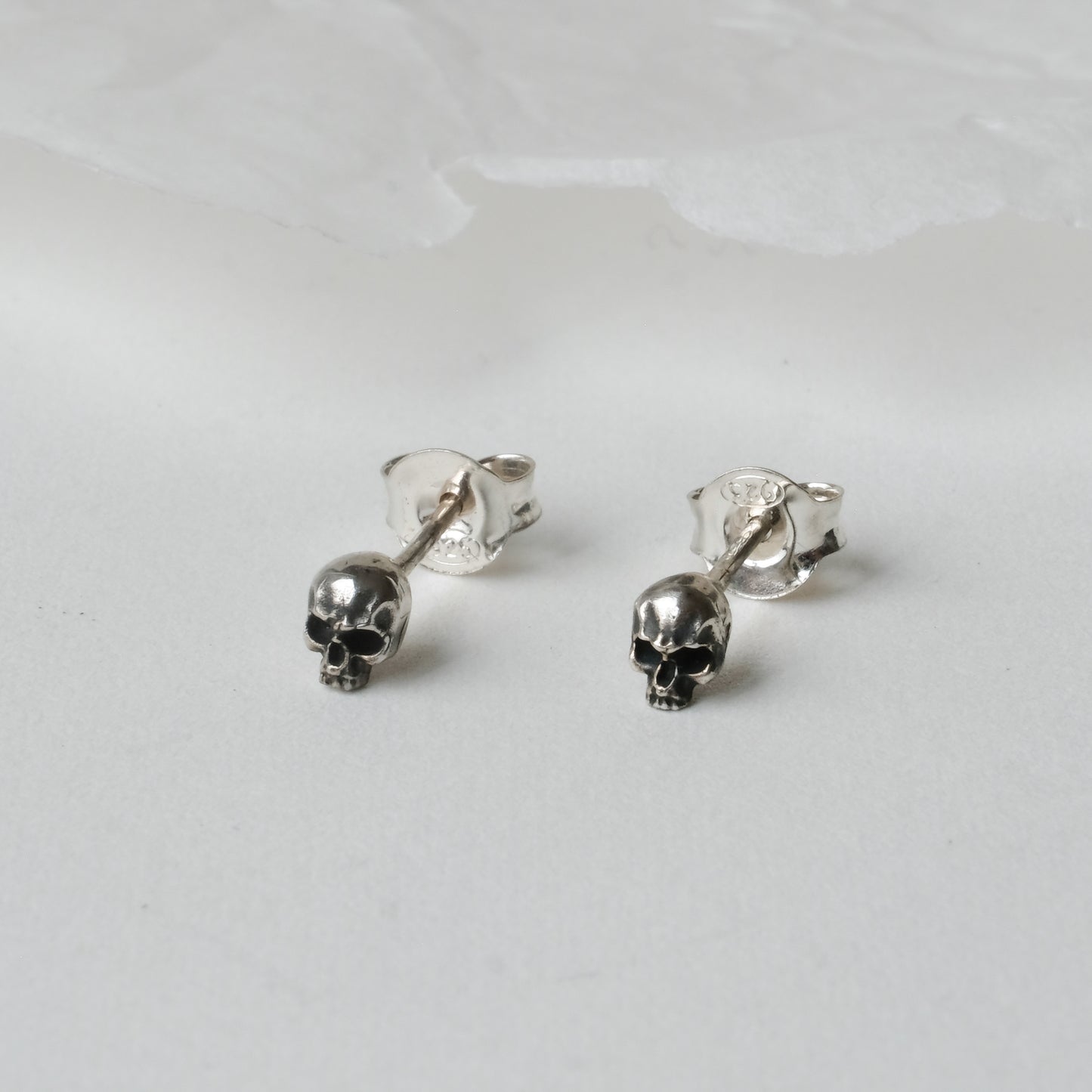 Sterling silver tiny skull studs by Charlie Shires
