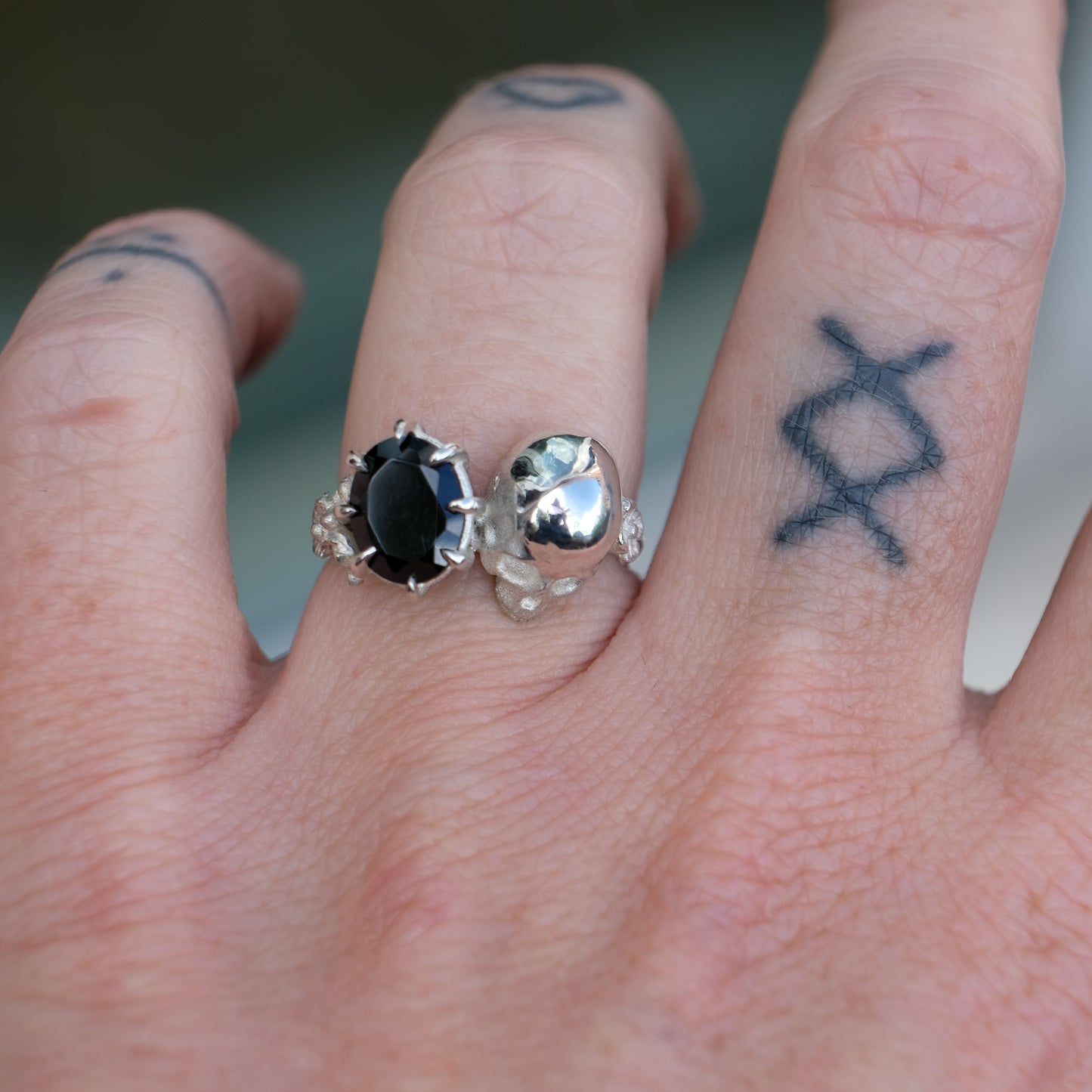 Silver skull and black spinel ring with decorative flowers by Charlie Shires jewellery
