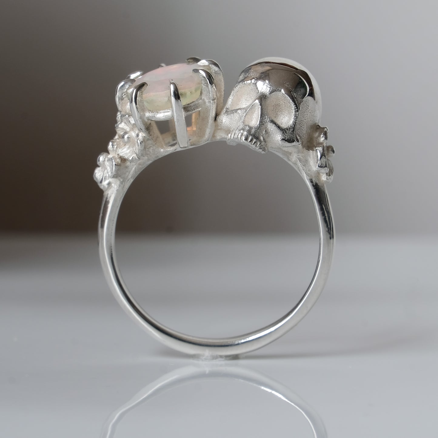 Silver skull and white opal ring with decorative flowers