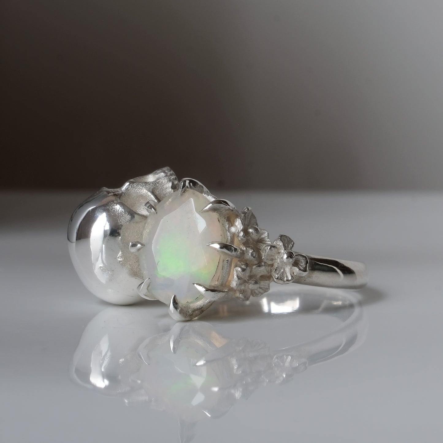 Silver skull and white opal ring with decorative flowers