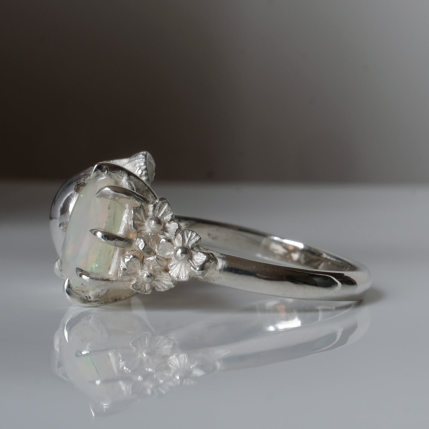 Silver skull and white opal ring with decorative flowers