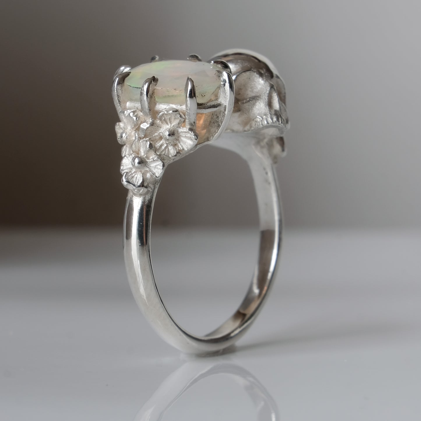 Silver skull and white opal ring with decorative flowers
