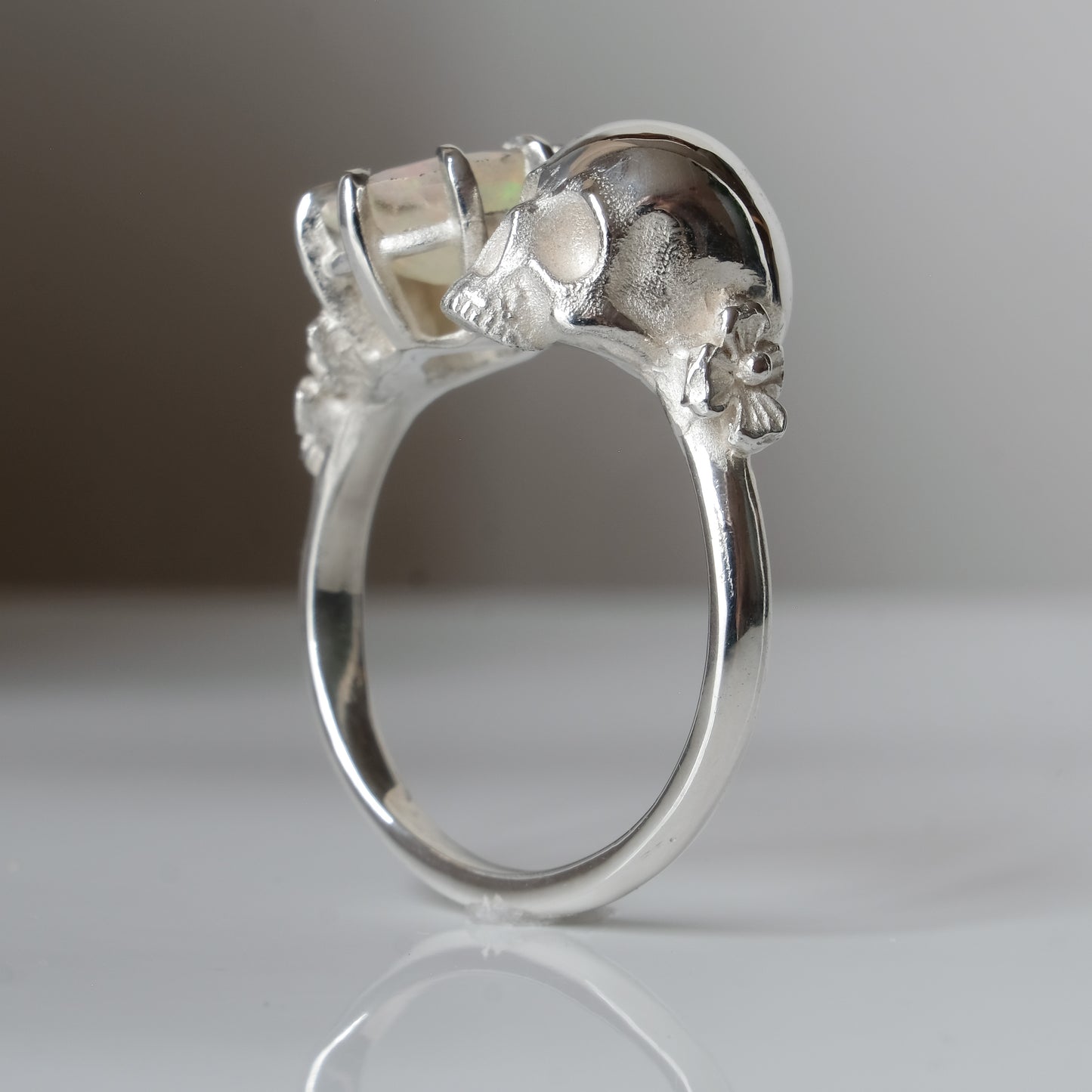 Silver skull and white opal ring with decorative flowers