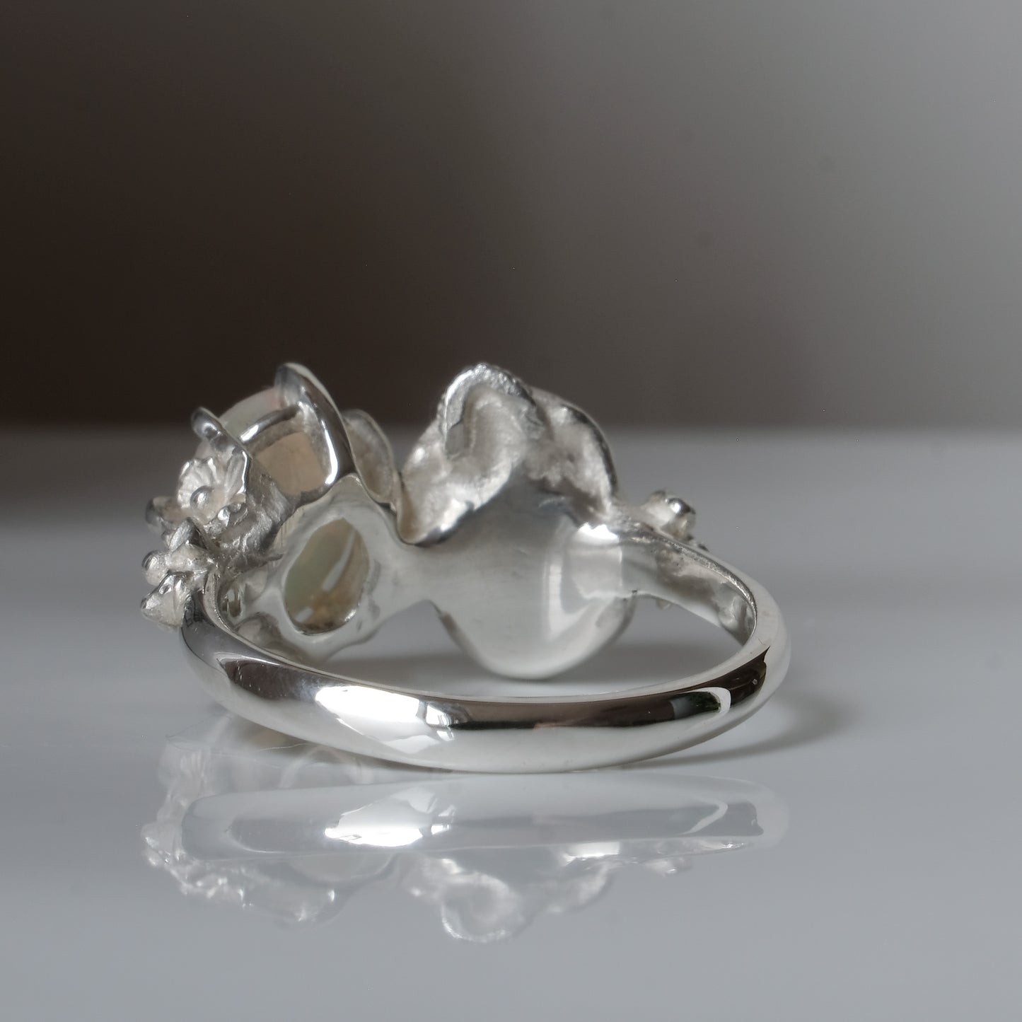 Silver skull and white opal ring with decorative flowers