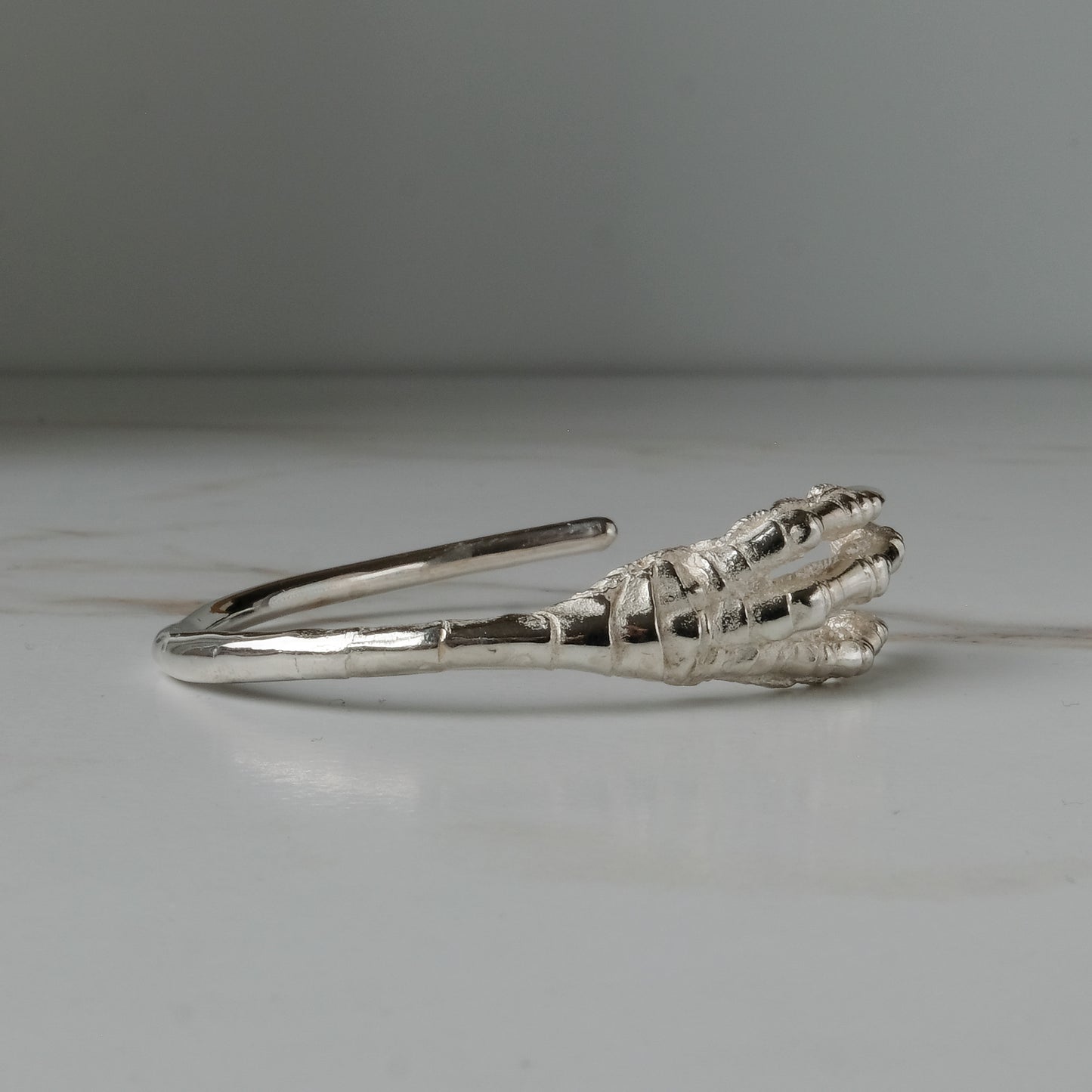 Sterling silver birds claw talon bangle handmade in London by Charlie Shires