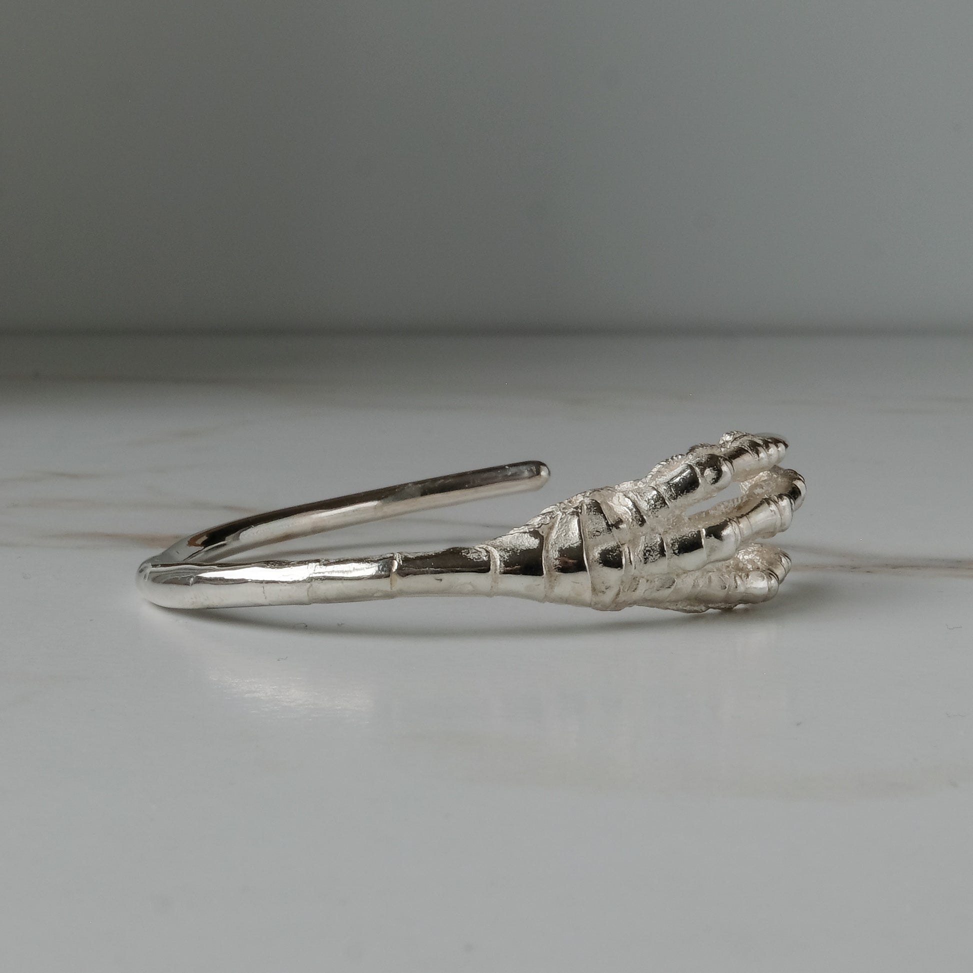 Sterling silver birds claw talon bangle handmade in London by Charlie Shires