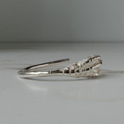 Sterling silver birds claw talon bangle handmade in London by Charlie Shires