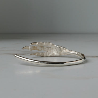 Sterling silver birds claw talon bangle handmade in London by Charlie Shires