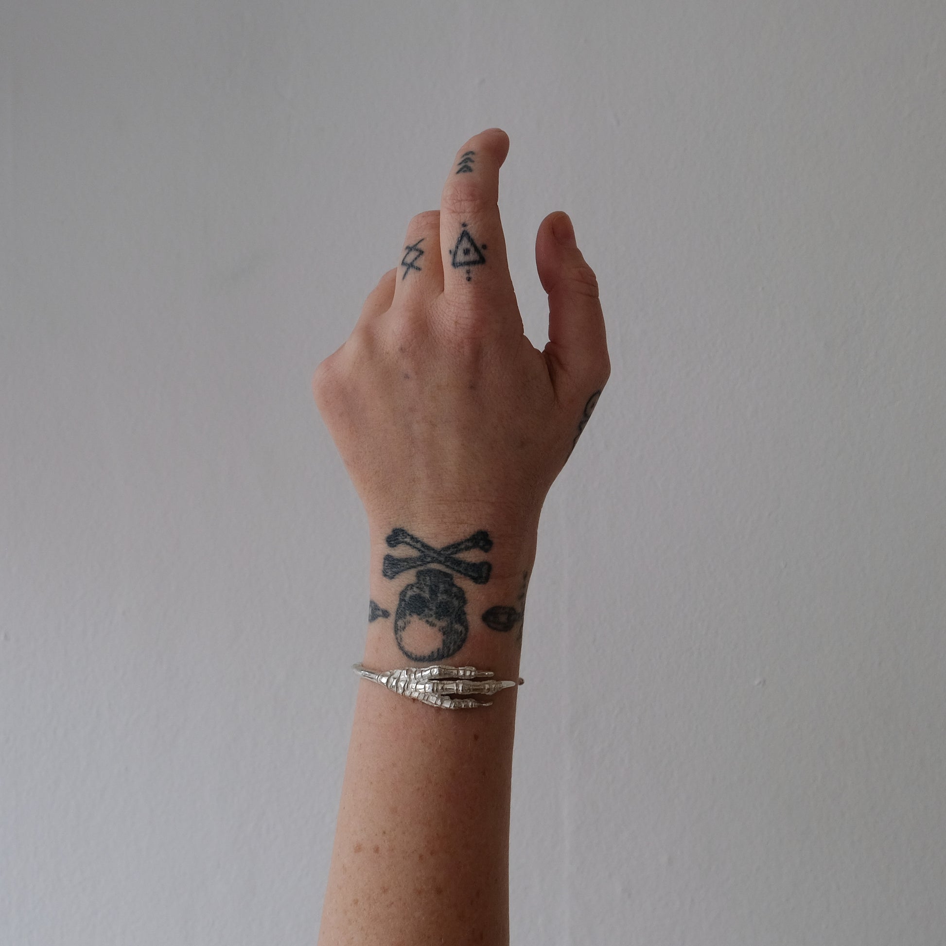 Sterling silver birds claw talon bangle handmade in London by Charlie Shires