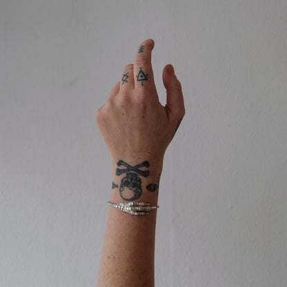 Sterling silver birds claw talon bangle handmade in London by Charlie Shires