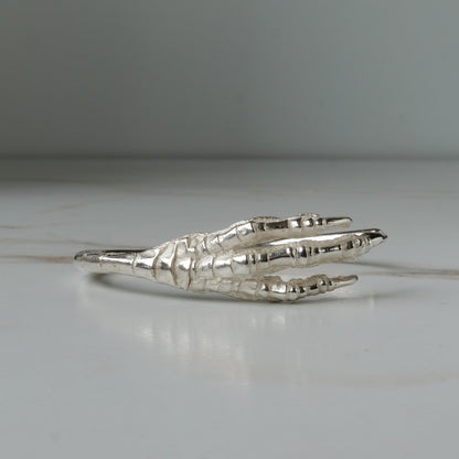 Sterling silver birds claw talon bangle handmade in London by Charlie Shires