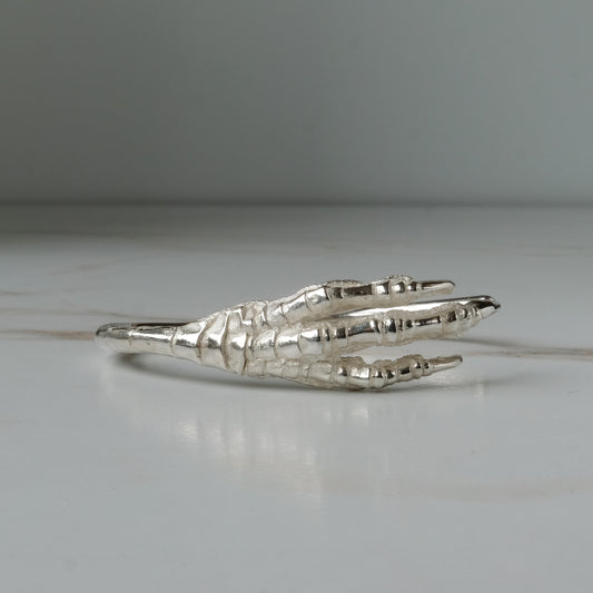 Sterling silver birds claw talon bangle handmade in London by Charlie Shires