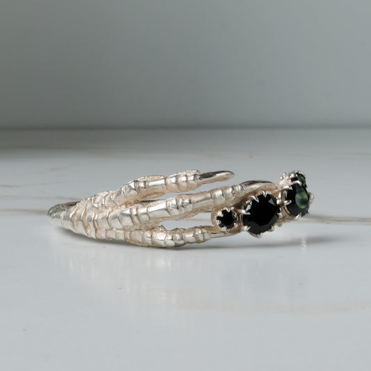 Sterling silver birds claw talon bangle handmade with black spinel stones and flowers in London by Charlie Shires