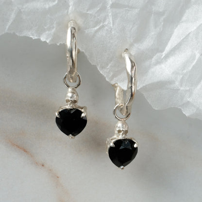 Sterling silver Annie molten hoops with drop black spinel hearts and skulls. Made in London by Charlie Shires