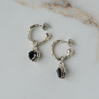 Sterling silver Annie molten hoops with drop black spinel hearts and skulls. Made in London by Charlie Shires