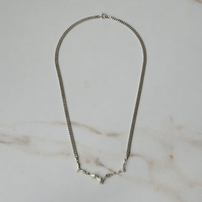 Three bat necklace on curb link chain, made in sterling silver by Charlie Shires in London