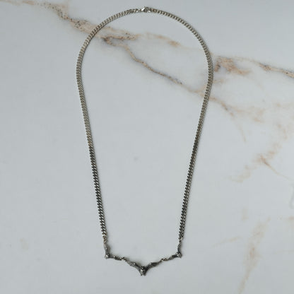 Three bat necklace on curb link chain, made in sterling silver by Charlie Shires in London