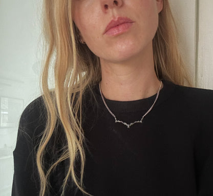 Three bat necklace on curb link chain, made in sterling silver by Charlie Shires in London