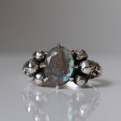 Three skull ring with central labradorite and decorative band made in sterling silver in London by Charlie Shires