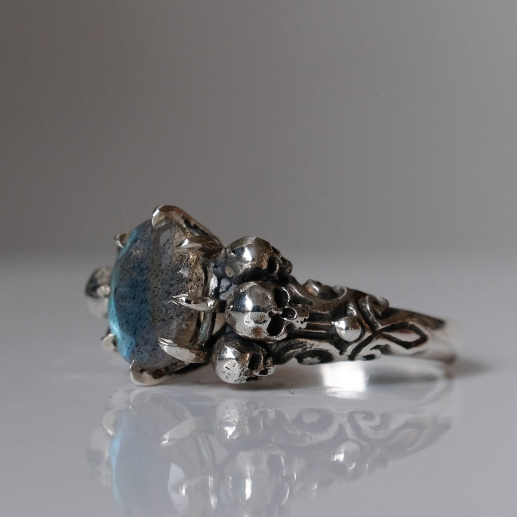 Three skull ring with central labradorite and decorative band made in sterling silver in London by Charlie Shires