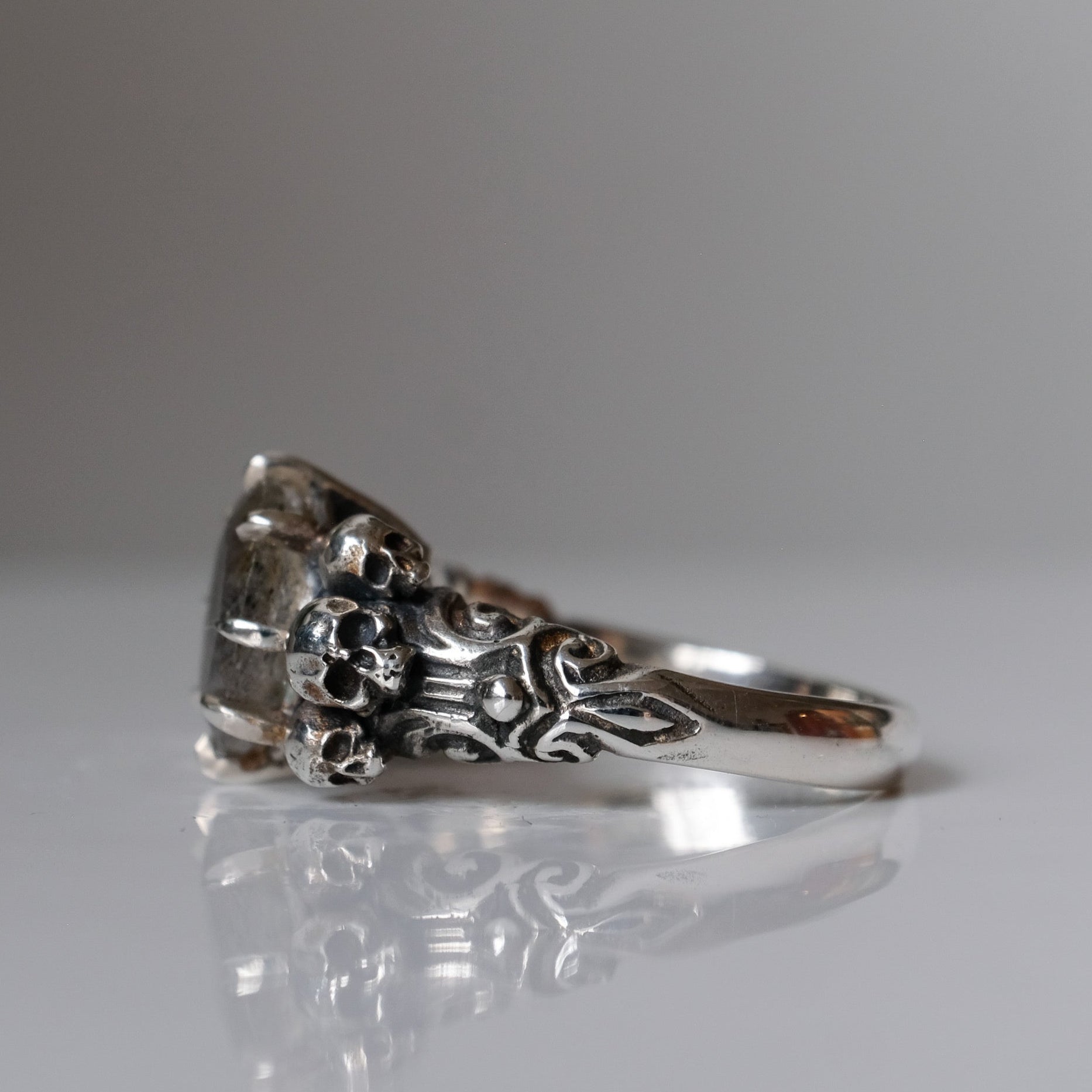 Three skull ring with central labradorite and decorative band made in sterling silver in London by Charlie Shires