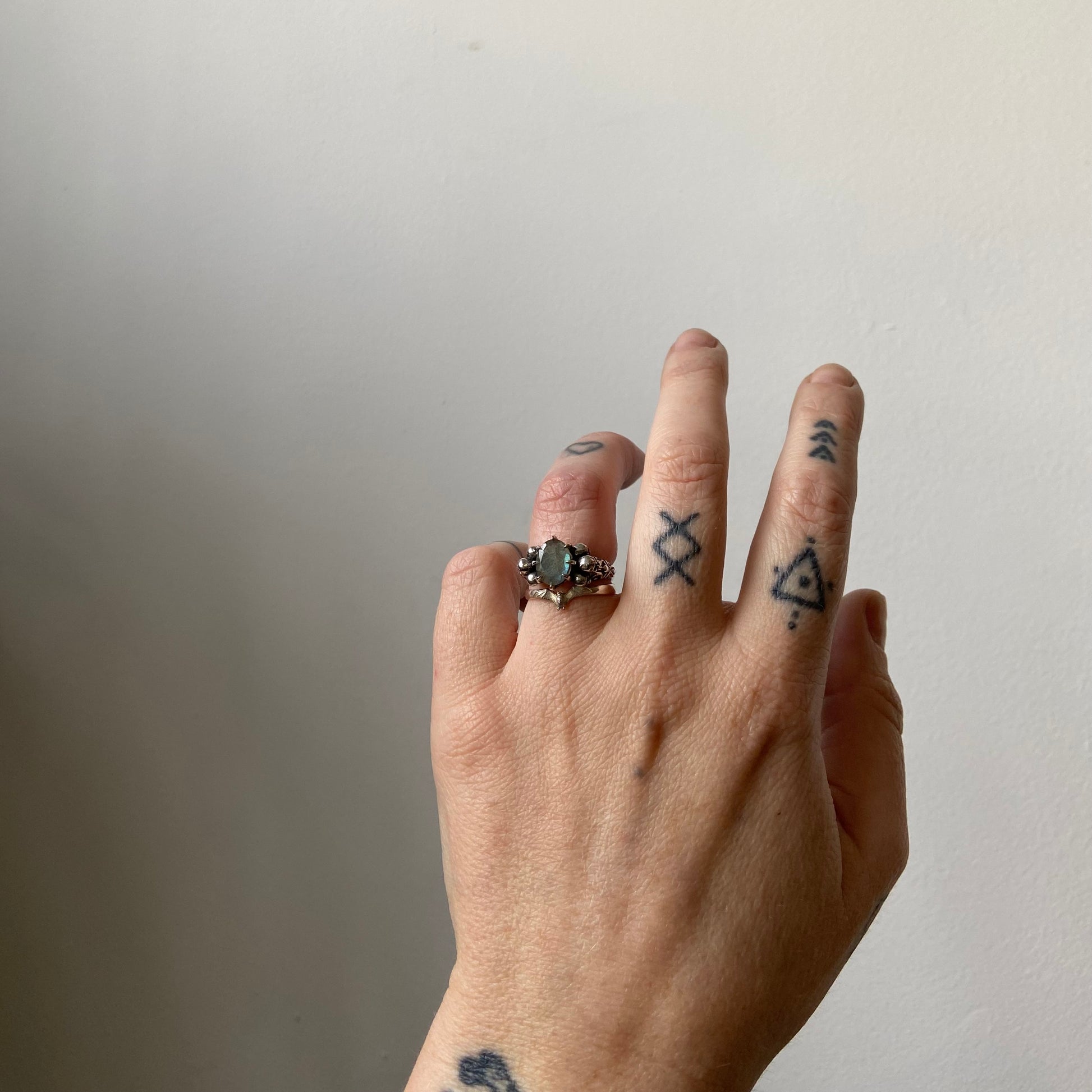 Three skull ring with central labradorite and decorative band made in sterling silver in London by Charlie Shires