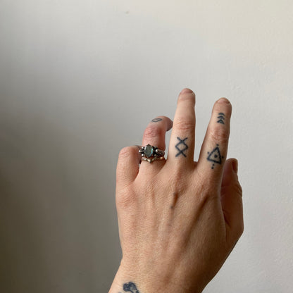 Three skull ring with central labradorite and decorative band made in sterling silver in London by Charlie Shires