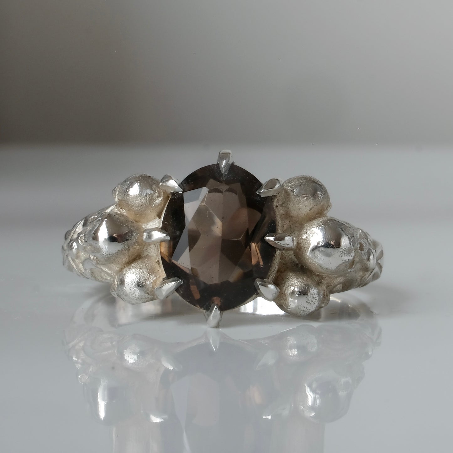 Three skull ring with central tourmaline and decorative band made in sterling silver in London by Charlie Shires