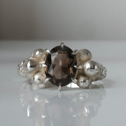 Three skull ring with central tourmaline and decorative band made in sterling silver in London by Charlie Shires