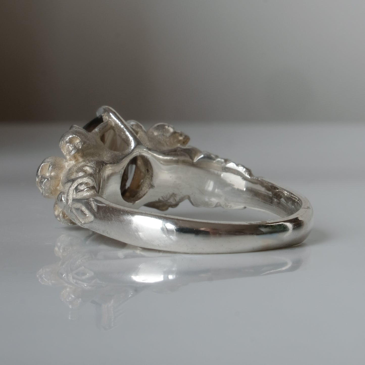 Three skull ring with central tourmaline and decorative band made in sterling silver in London by Charlie Shires