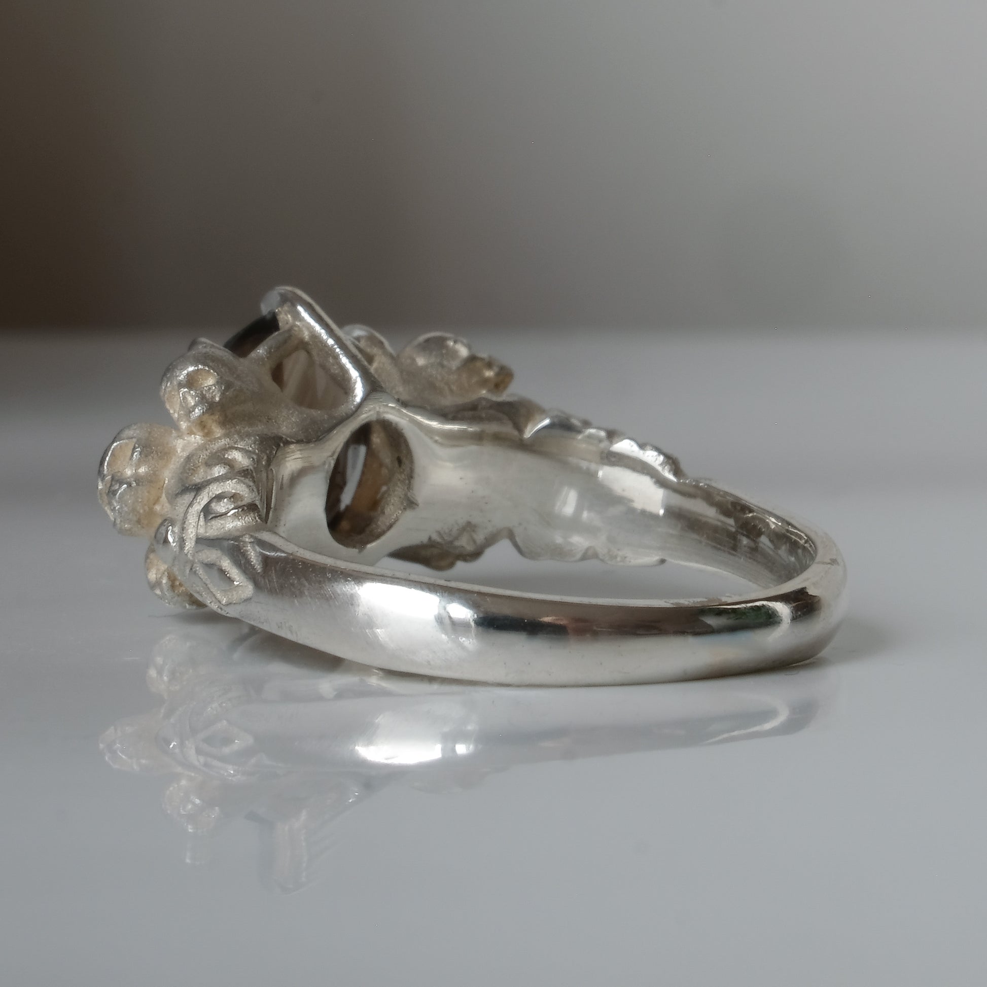 Three skull ring with central tourmaline and decorative band made in sterling silver in London by Charlie Shires