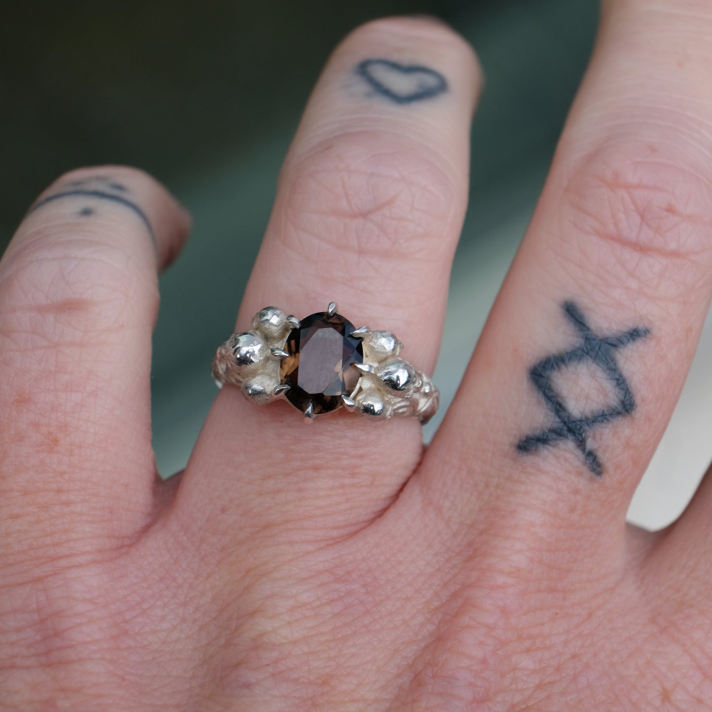 Three skull ring with central tourmaline and decorative band made in sterling silver in London by Charlie Shires