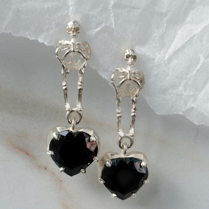 Skeleton earrings with black spinel heart shaped stones made in sterling silver in London by Charlie Shires