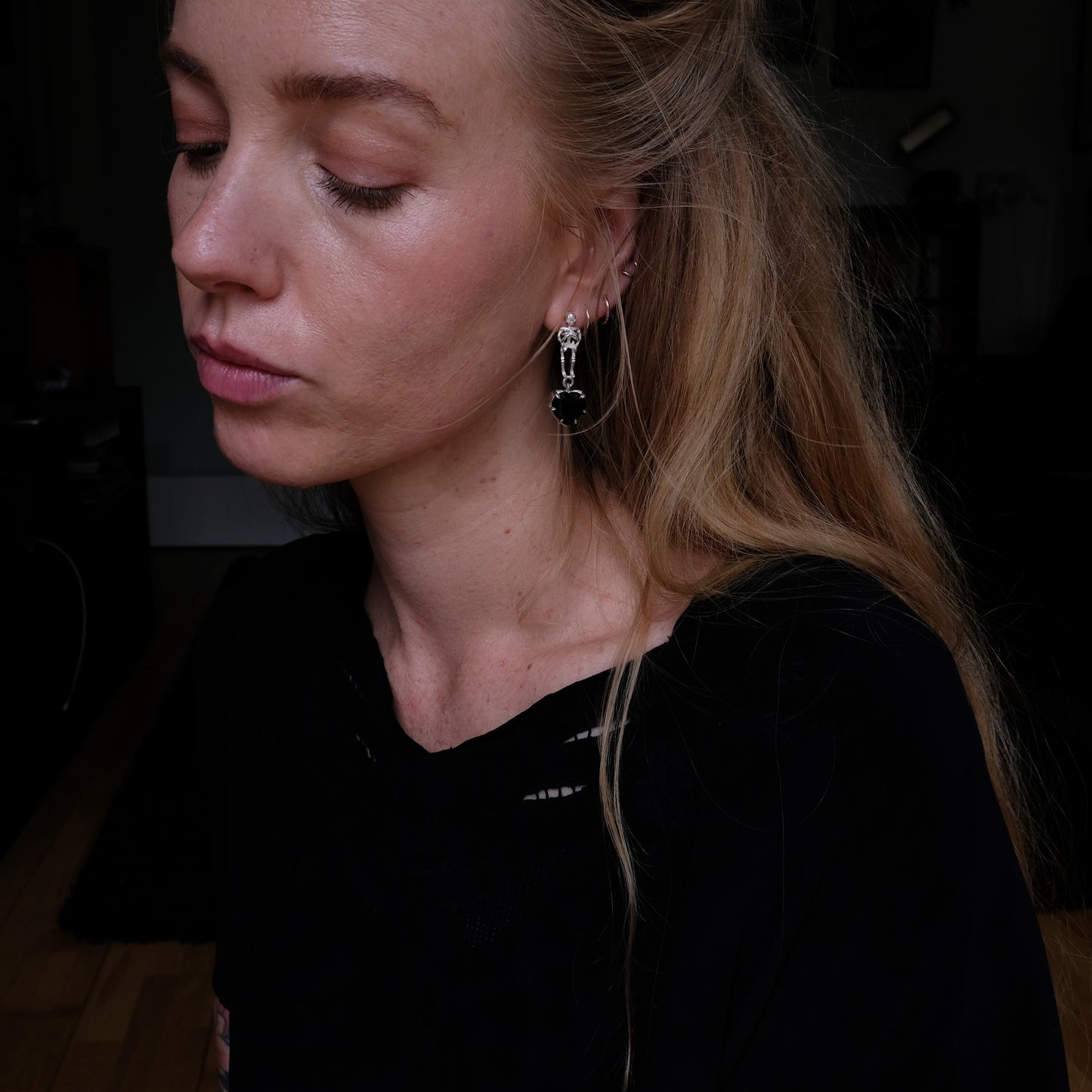 Skeleton earrings with black spinel heart shaped stones made in sterling silver in London by Charlie Shires