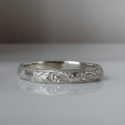 Silver band engraved with skulls, flourishes and flowers by Charlie Shires