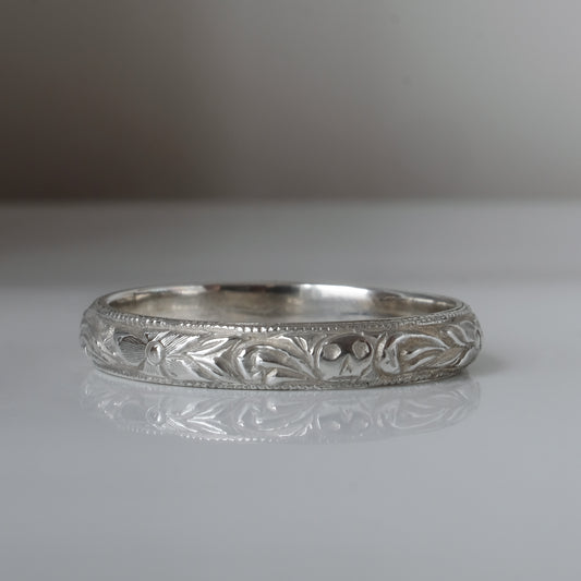 Silver band engraved with skulls, flourishes and flowers by Charlie Shires
