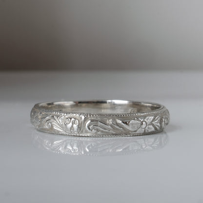 Silver band engraved with skulls, flourishes and flowers by Charlie Shires
