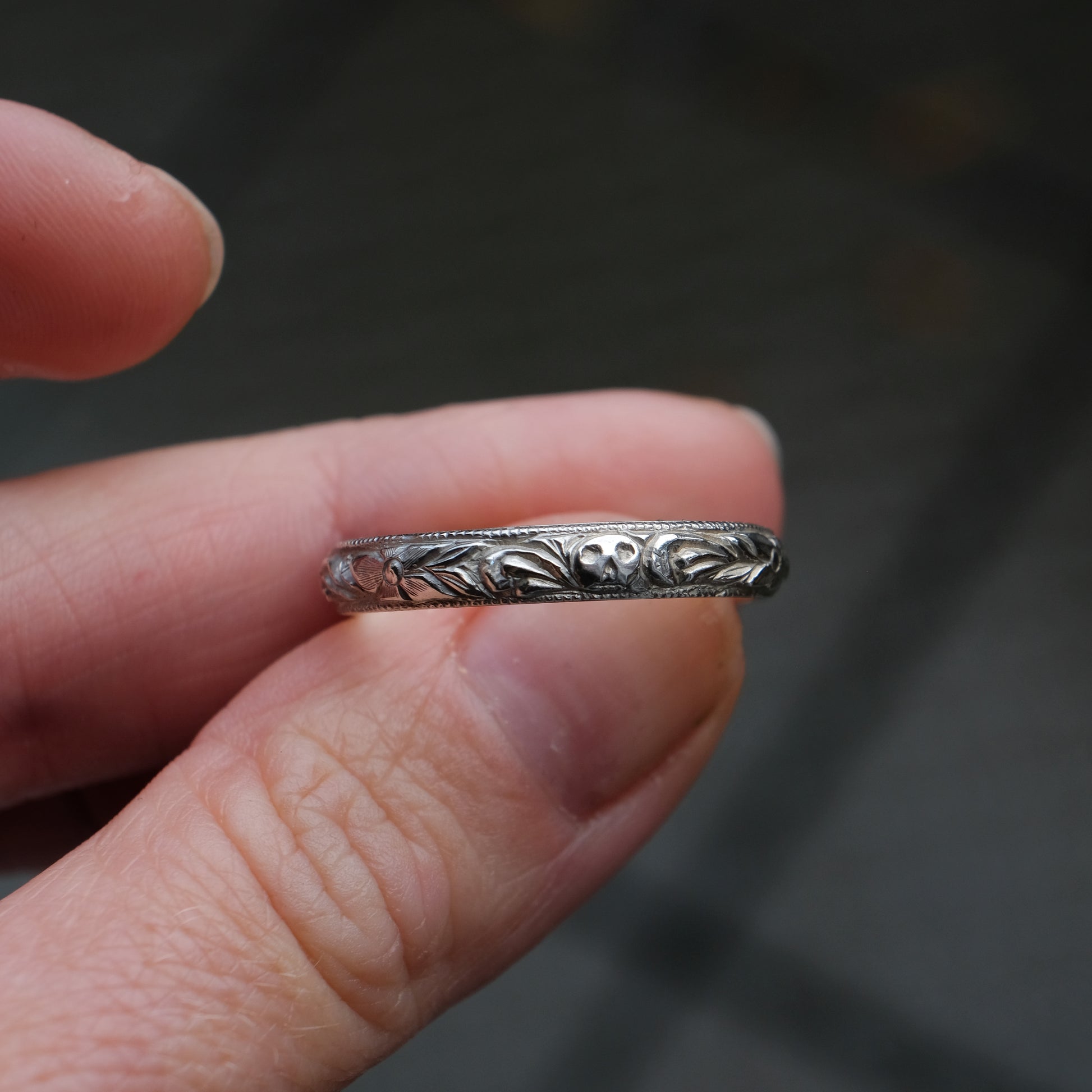 Silver band engraved with skulls, flourishes and flowers by Charlie Shires