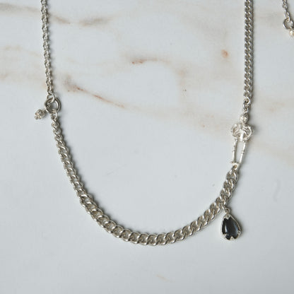 Sterling silver curb link necklace with skeleton and hanging moonstone. Photographed on white background. Made in London by Charlie Shires