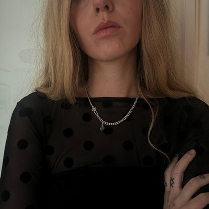 Sterling silver curb link necklace with skeleton and hanging moonstone. Photographed on white background. Made in London by Charlie Shires