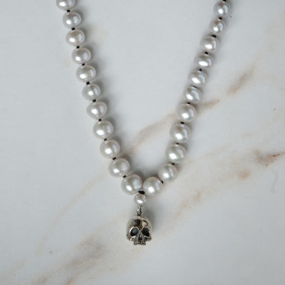 Hand strung grey freshwater pearls with a large sterling silver skull, made by hand in London by Charlie Shires