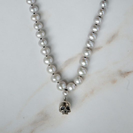 Hand strung grey freshwater pearls with a large sterling silver skull, made by hand in London by Charlie Shires