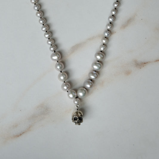 Hand strung grey freshwater pearls with a medium sterling silver skull, made by hand in London by Charlie Shires