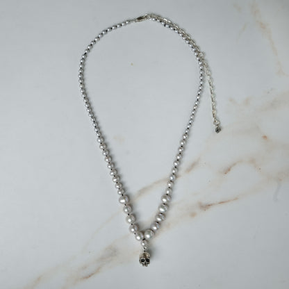 Hand strung grey freshwater pearls with a medium sterling silver skull, made by hand in London by Charlie Shires